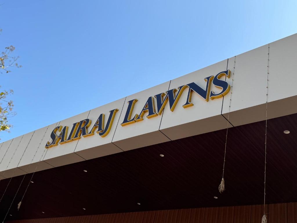 a sign on the side of a building at Sairaj Lawns in Belgaum