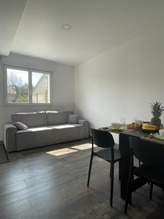 un salon avec un canapé et une table dans l'établissement Maison Cozy à Saint-Brevin à Deux Pas de la Mer, à Saint-Brévin-les-Pins