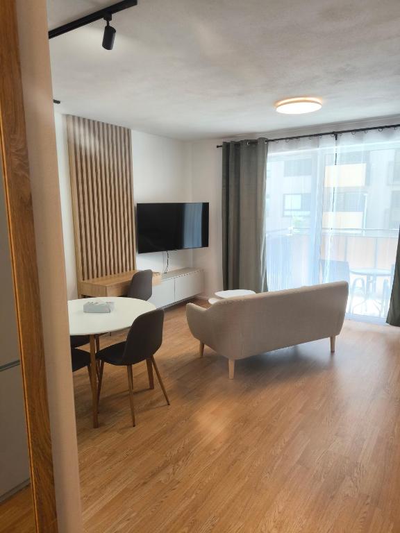 a living room with a couch and a table at modern apartment in Senica
