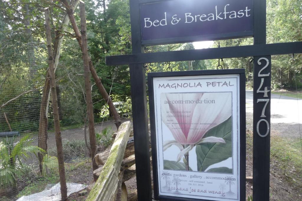 a sign for the bed and breakfast with a flower at Magnolia Petal in Ganges