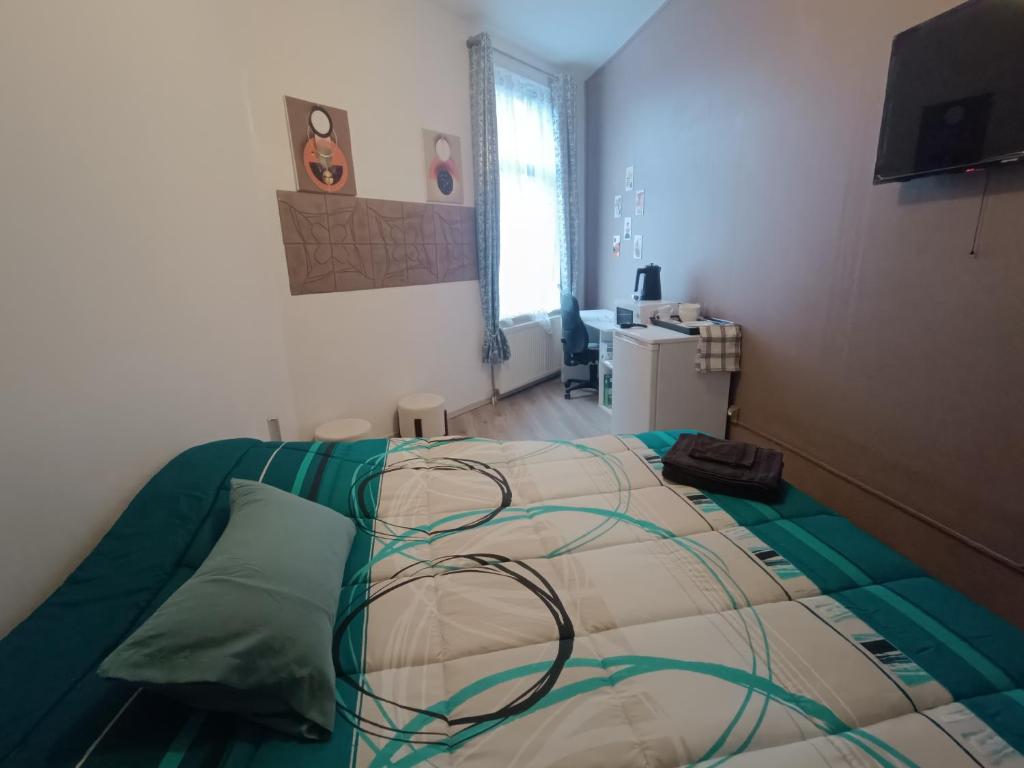 a bedroom with a large bed with at Chez Oppo in Charleroi