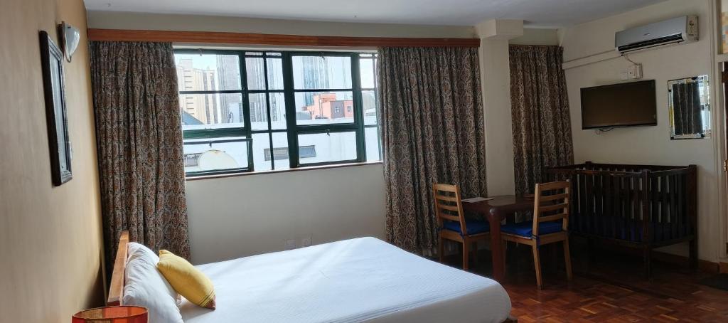 Postel nebo postele na pokoji v ubytování Kenya Comfort Hotel