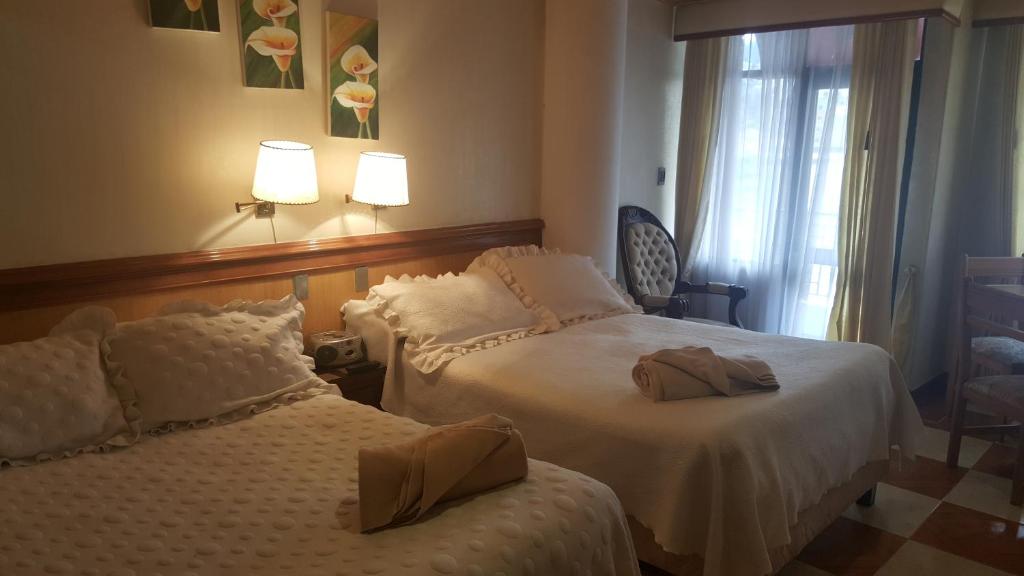 Postel nebo postele na pokoji v ubytování Hotel Inter Bogotá