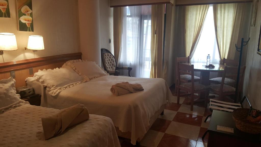 Postel nebo postele na pokoji v ubytování Hotel Inter Bogotá