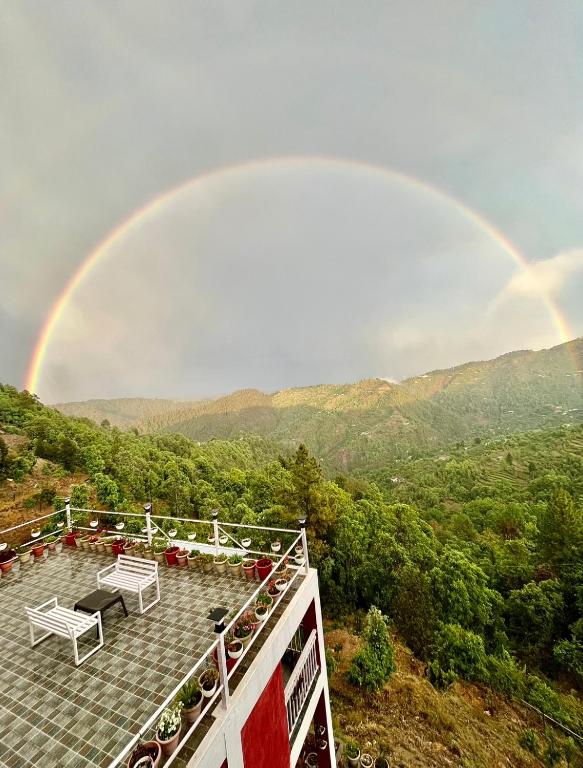 a rainbow in the sky with at EcoEscape Mukteshwar in Mukteswar