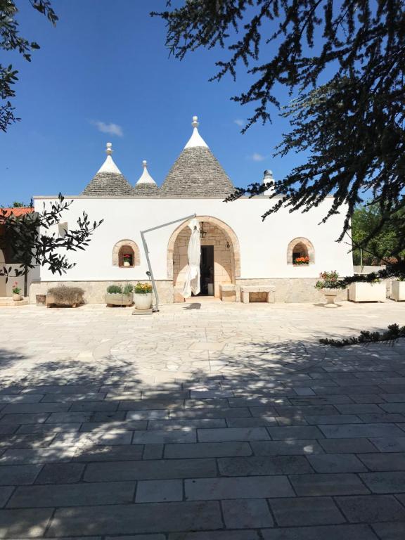 a large white building with a large patio at I Trulli di Mimì in Monopoli