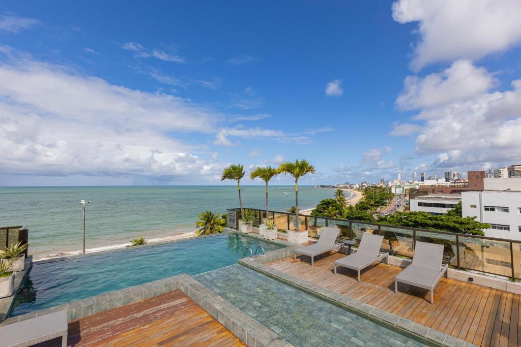 a view of the ocean from the balcony of a building at Arpoar Flat 118 - De frente para o mar in João Pessoa