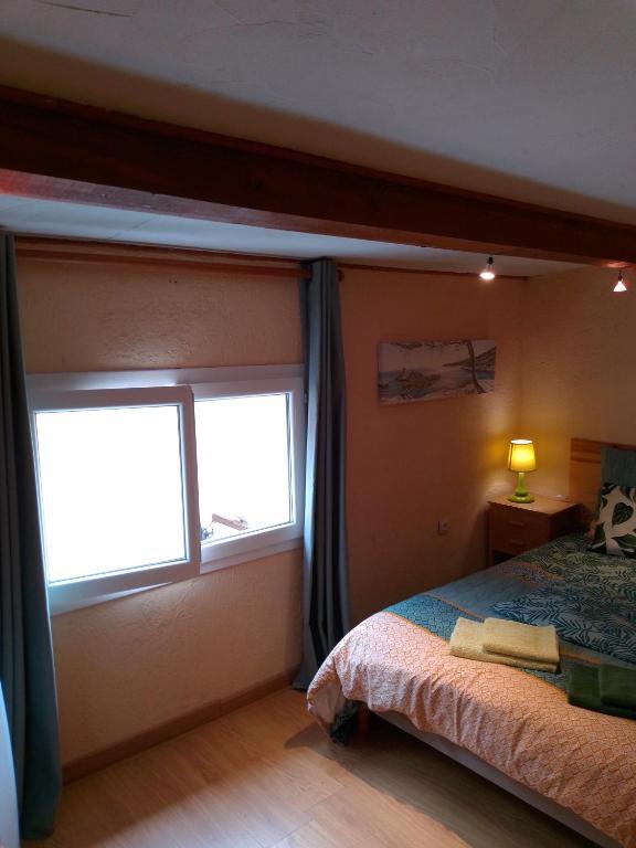 a bedroom with a bed and a window at Cabanon du Pêcheur, Parc National des Calanques in Marseille