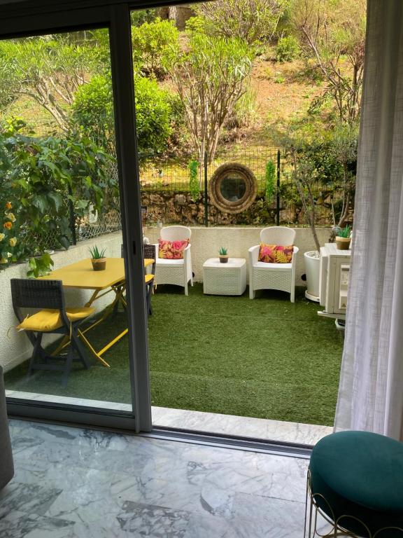 Zimmer mit einer Terrasse mit Tisch und Stühlen in der Unterkunft Charmant Studio in Cannes