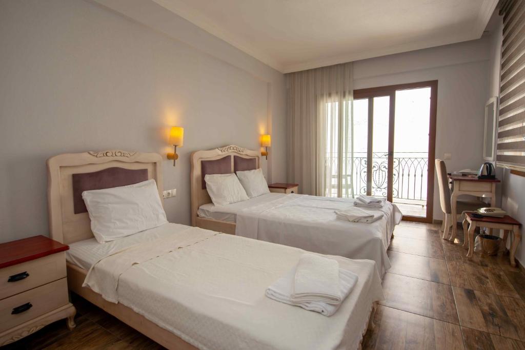 Postel nebo postele na pokoji v ubytování Cennet Life Hotel
