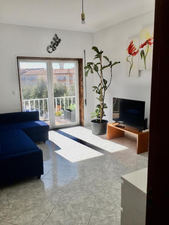 a living room with a blue couch and a fireplace at CALIFORNIA dream in Peniche
