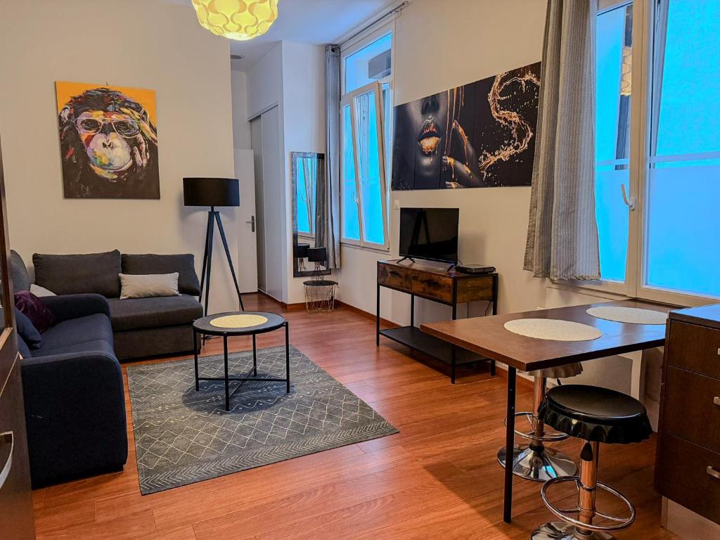 a living room with a couch and a table at Studio Lumineux Proche Centre et Port in Port-Vendres