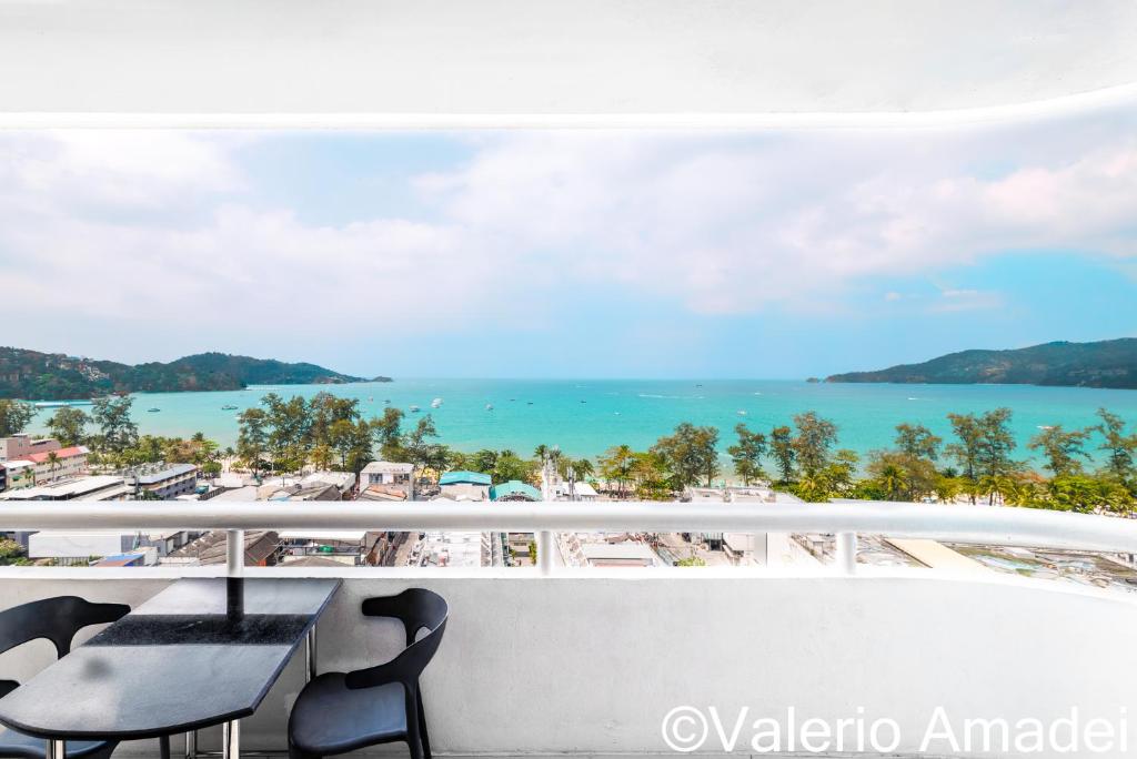 a balcony with chairs and a view of the beach at Patong Tower Amazing Sea View 12 by PHR in Patong Beach