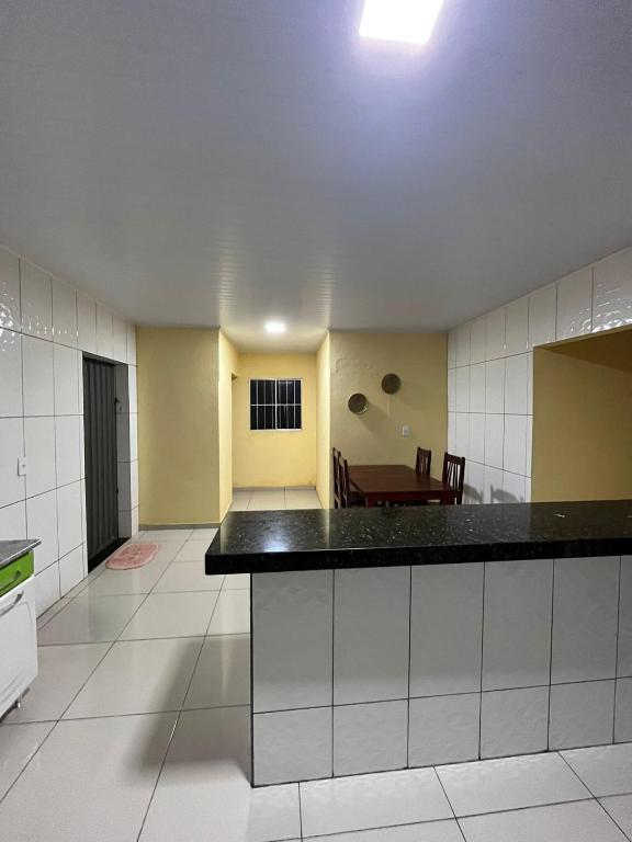 a kitchen with a counter and a dining room at Toca da Onça in Coronel José Diaz