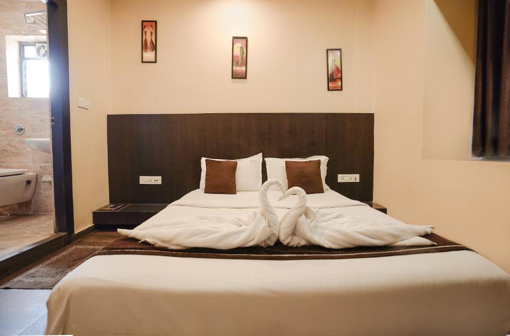 Postel nebo postele na pokoji v ubytování Hotel Sheldon International Near Science City
