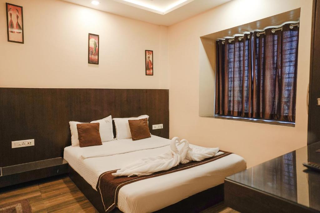 Postel nebo postele na pokoji v ubytování Hotel Sheldon International Near Science City