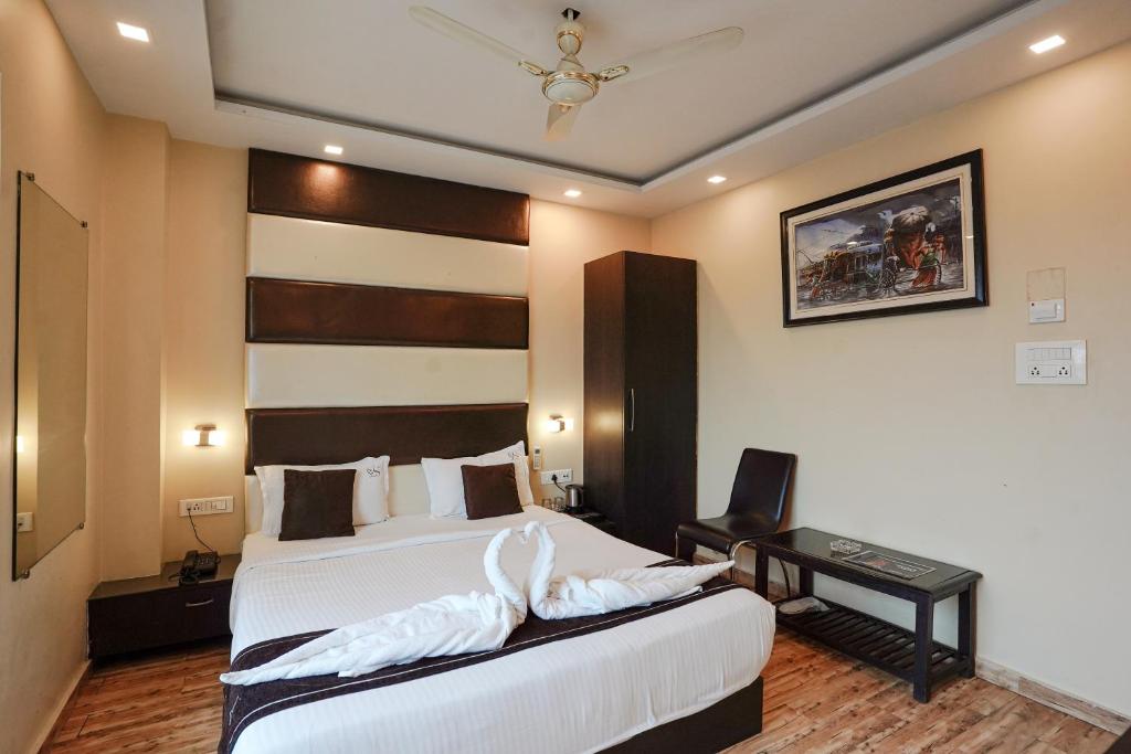 Postel nebo postele na pokoji v ubytování Hotel Sheldon International Near Science City