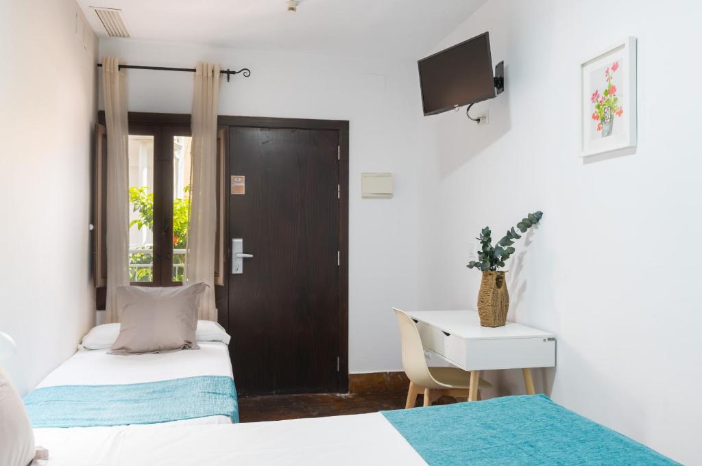Postel nebo postele na pokoji v ubytování Hotel Boutique Puerta del Rincón