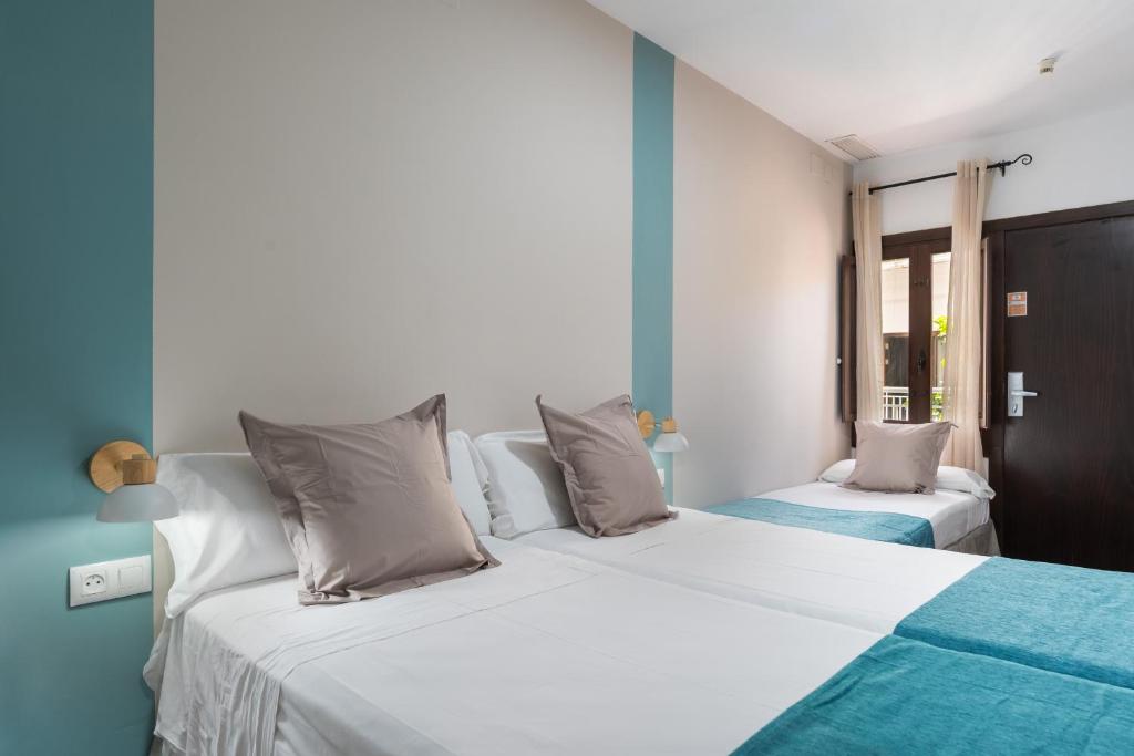 Postel nebo postele na pokoji v ubytování Hotel Boutique Puerta del Rincón