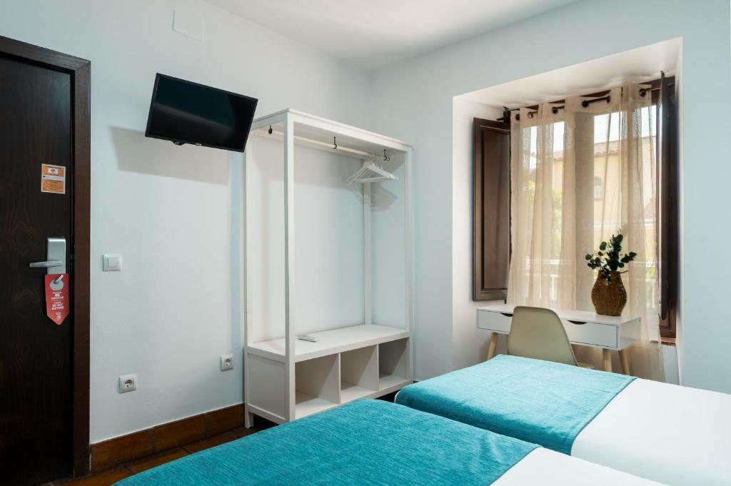 Postel nebo postele na pokoji v ubytování Hotel Boutique Puerta del Rincón
