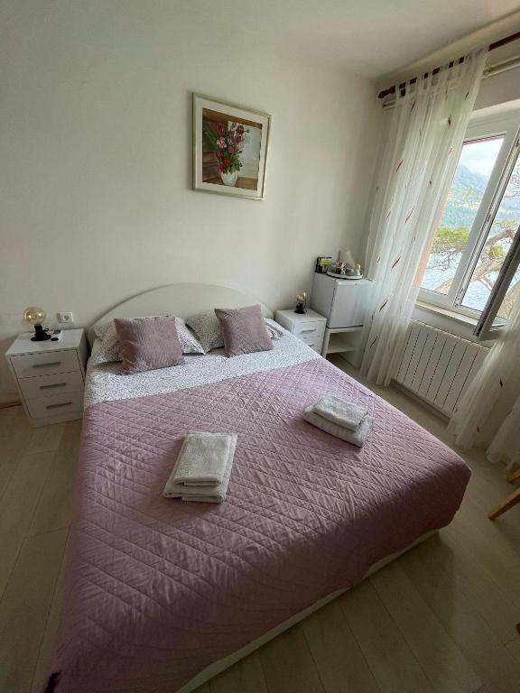 Postel nebo postele na pokoji v ubytování Apartments and rooms Nika