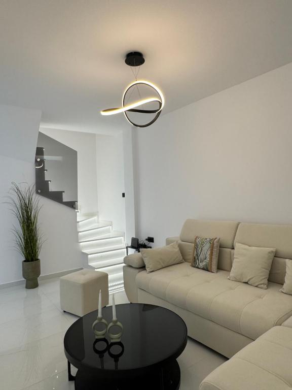 a living room with a couch and a table at Armonia Apartment in Pefkohori