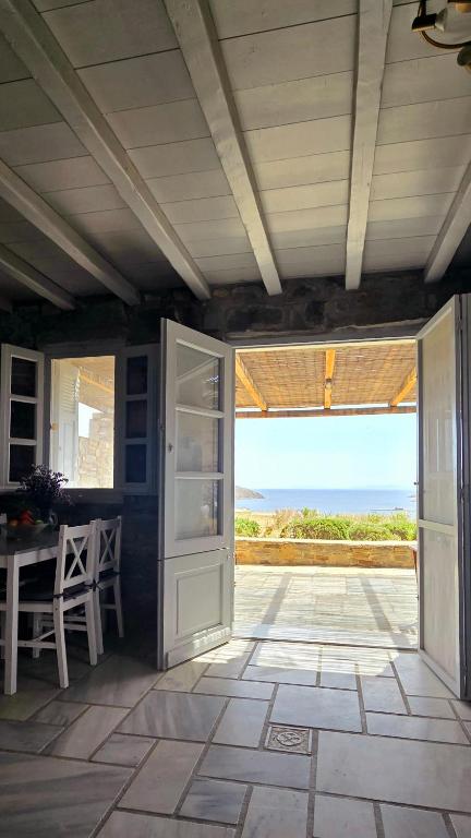 an open door to a patio with a view of the ocean at Serifos Rock Villa in Serifos Chora
