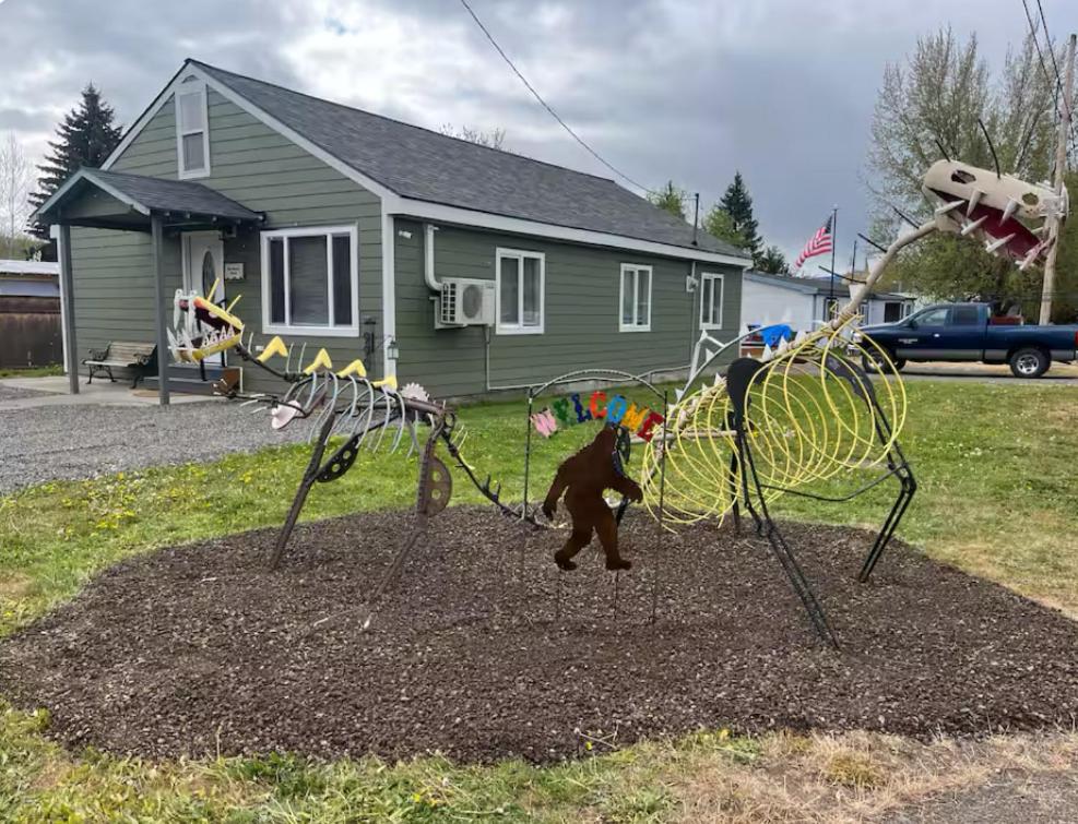 a man playing on a playground in front of a house at Blue Mountain Retreat in Elgin