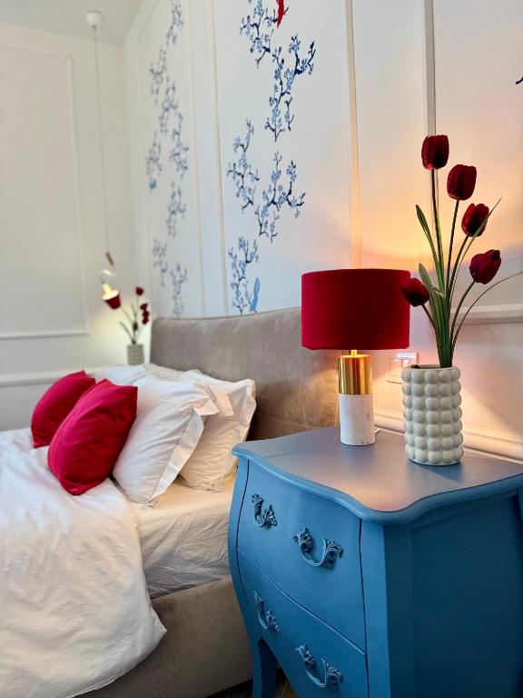 a bed with a blue end table with a lamp on it at Umi B&B in Giulianova