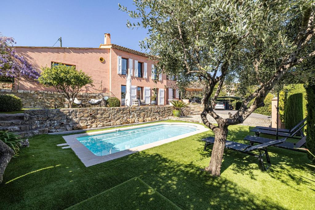 a house with a swimming pool in a yard at Villa Flore - Panoramic Sea View by Halldis in Vallauris