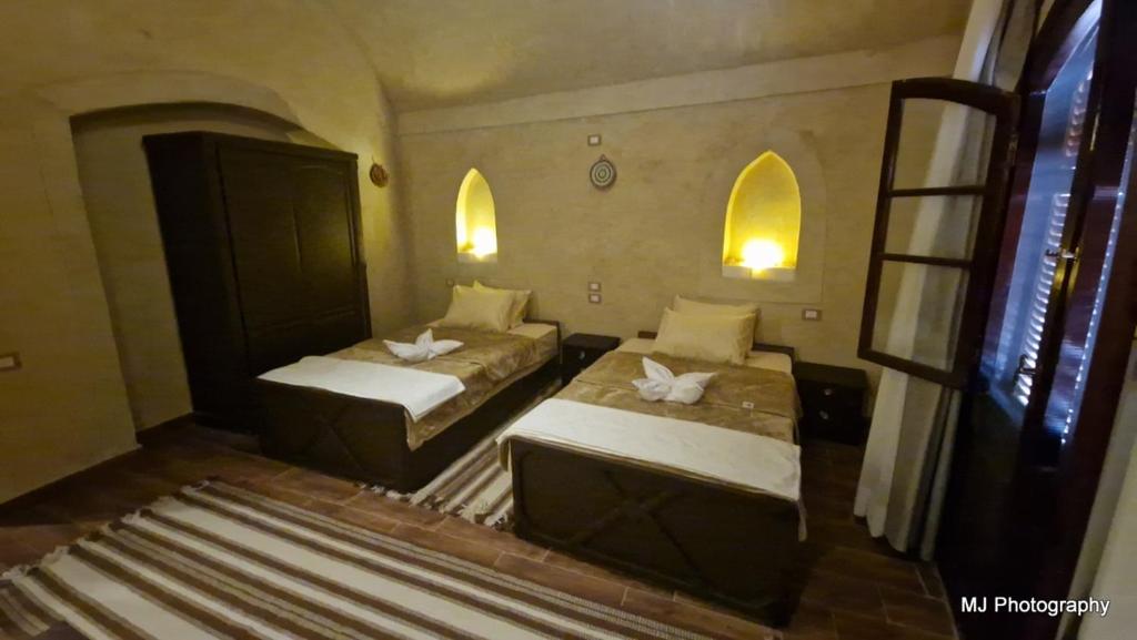 Postel nebo postele na pokoji v ubytování Hotel Talid