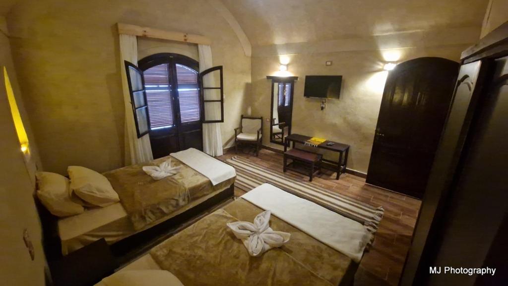 Postel nebo postele na pokoji v ubytování Hotel Talid
