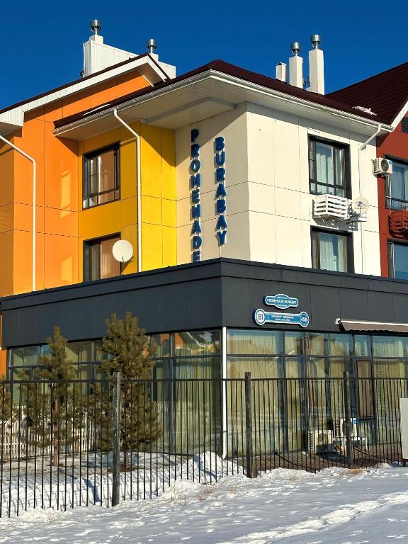 a building with a fence in front of it at Promenade Burabay 2 in Borovoye