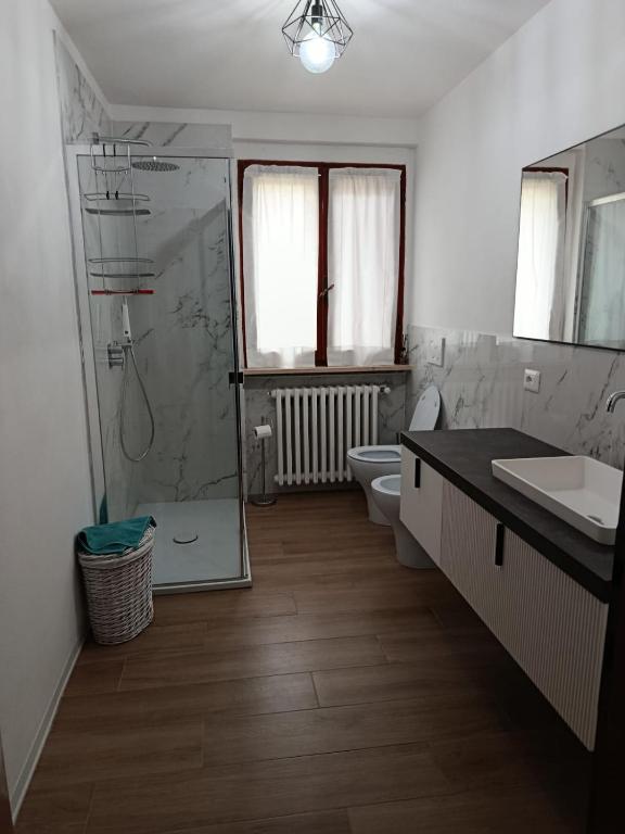 a bathroom with a shower and a toilet and a sink at Casa Eben-Haezer in Fiumana