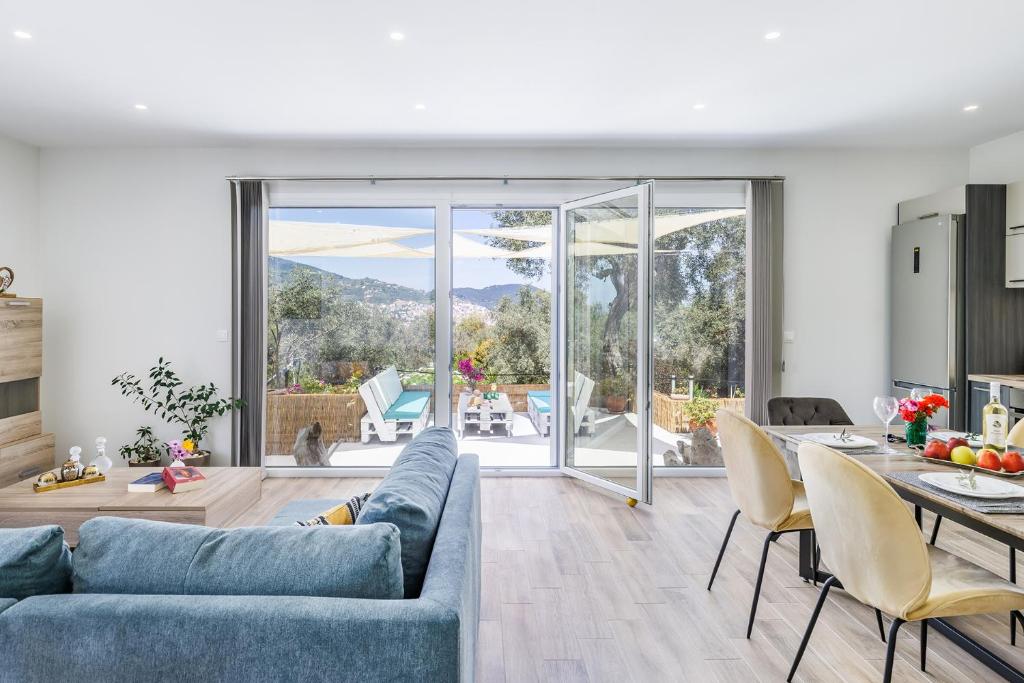 a living room with a blue couch and a table at Armonia Home - Pet Friendly & Spacious in Skopelos Town