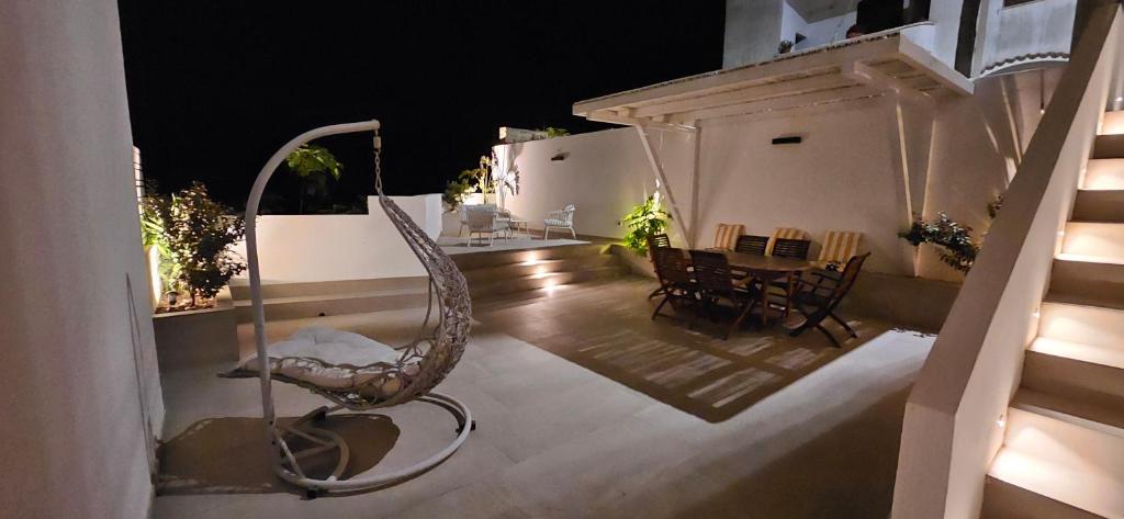 a chair on a balcony with a table and chairs at Canyon House Leuca in Leuca