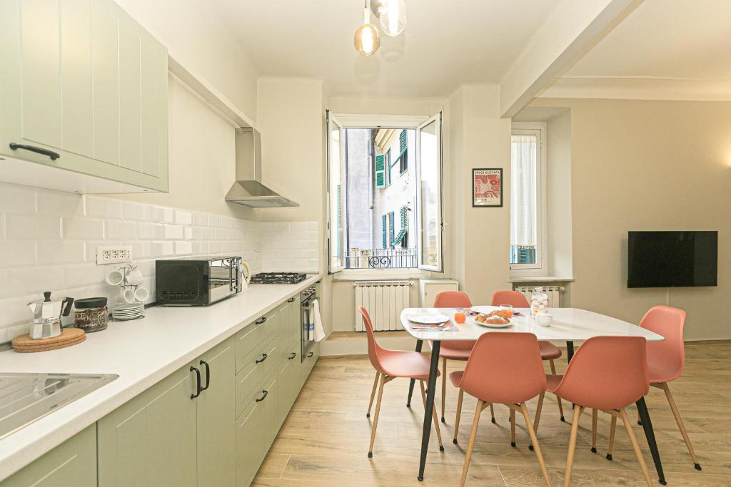 een keuken met een tafel en stoelen in een keuken bij Dimora dell'Opera Genova centro in Genua