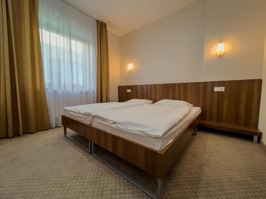 Postel nebo postele na pokoji v ubytování Hotel Arman
