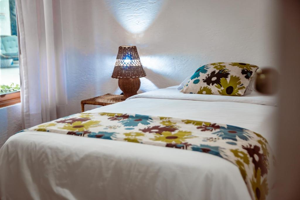 Postel nebo postele na pokoji v ubytování Hotel Miconia
