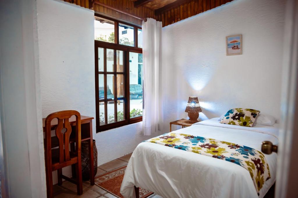 Postel nebo postele na pokoji v ubytování Hotel Miconia