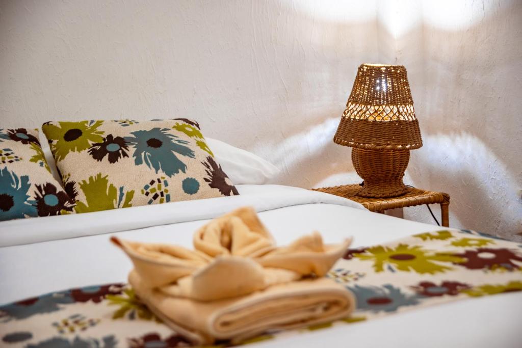 Postel nebo postele na pokoji v ubytování Hotel Miconia