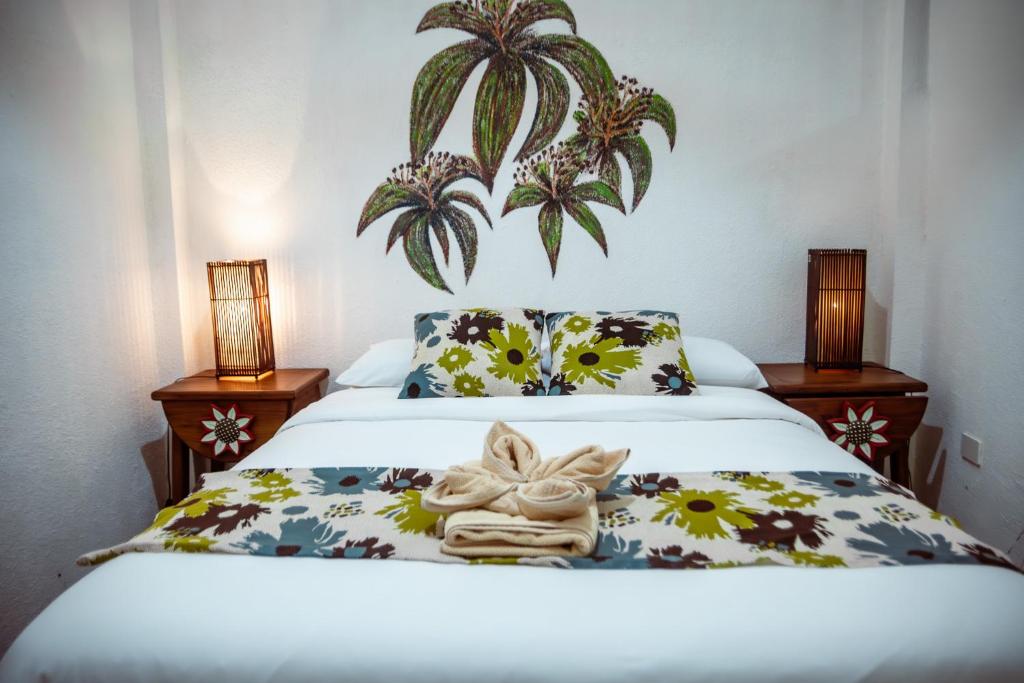 Postel nebo postele na pokoji v ubytování Hotel Miconia