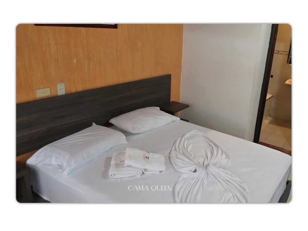 Postel nebo postele na pokoji v ubytování Hotel Orquidea Dorada R