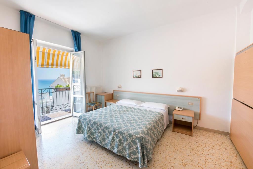 Postel nebo postele na pokoji v ubytování Stella Hotel