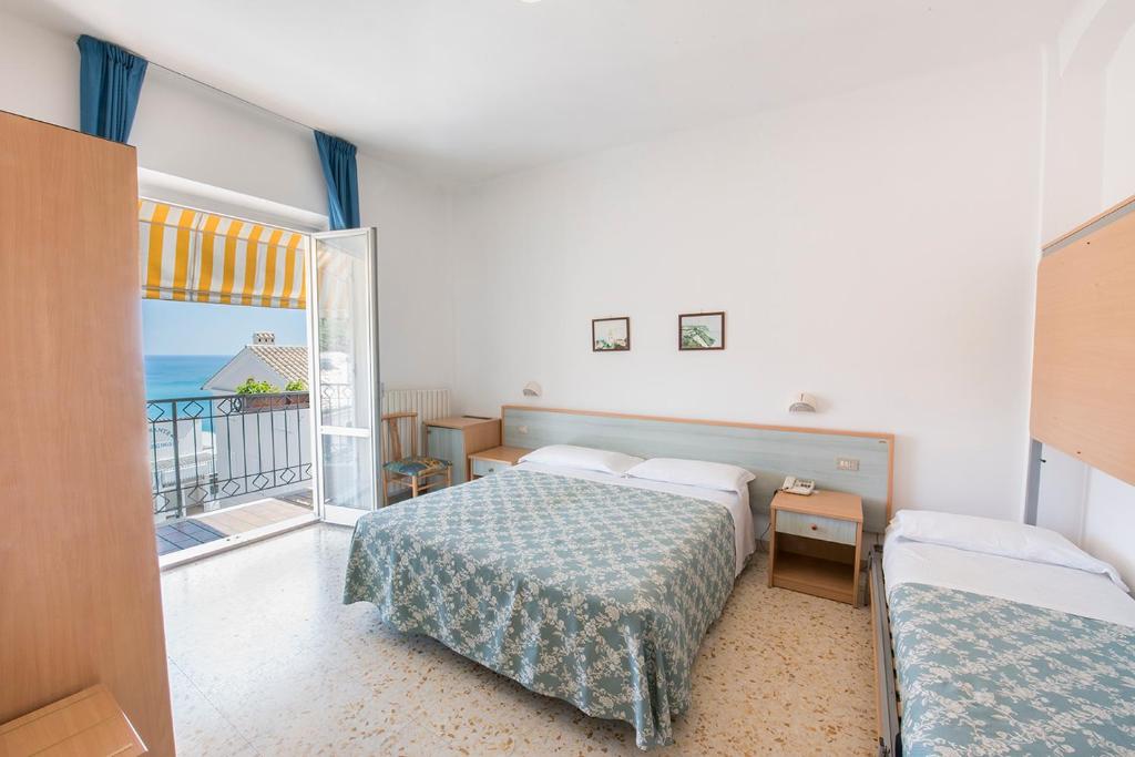 Postel nebo postele na pokoji v ubytování Stella Hotel