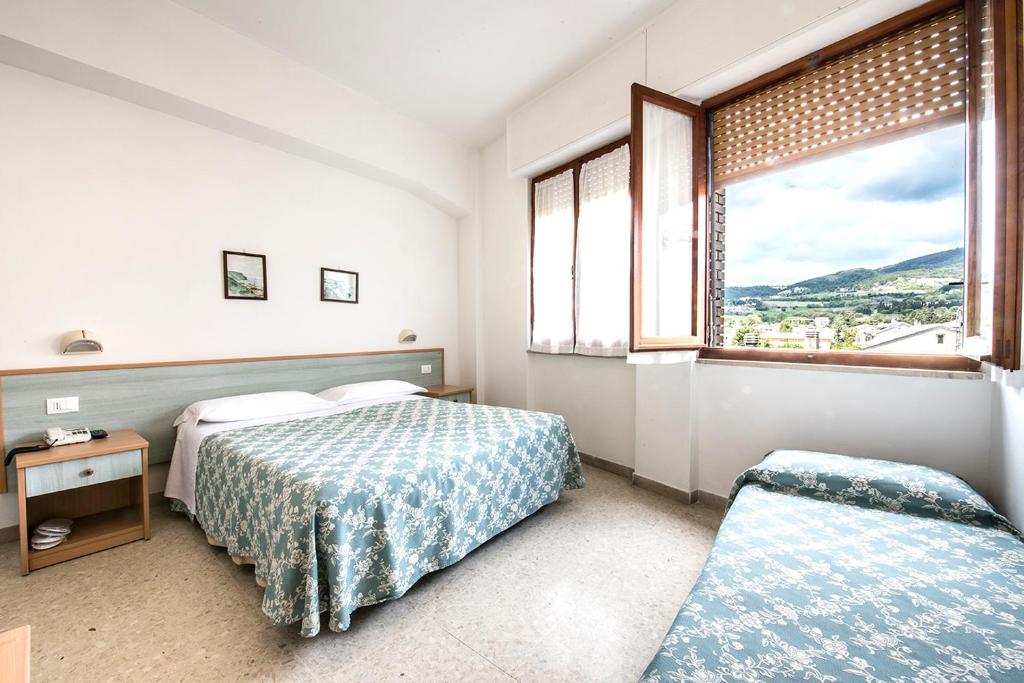 Postel nebo postele na pokoji v ubytování Stella Hotel