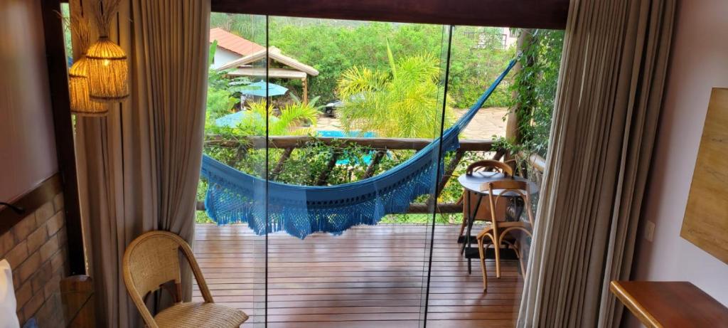 a room with a balcony with a hammock at Pousada Meu Talento in Alto Paraíso de Goiás