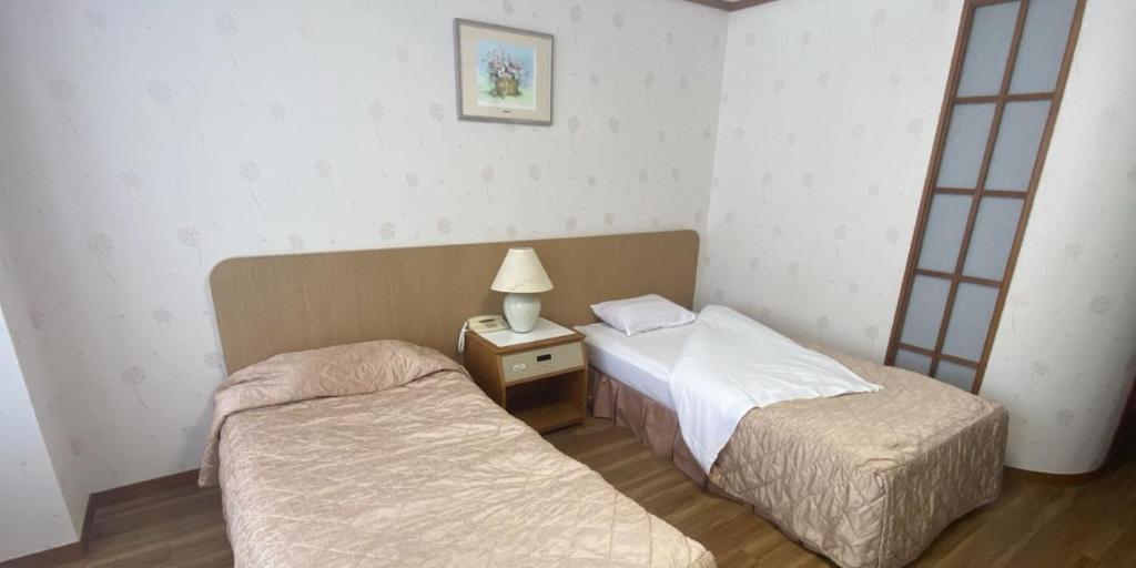 Postel nebo postele na pokoji v ubytování Kishotei