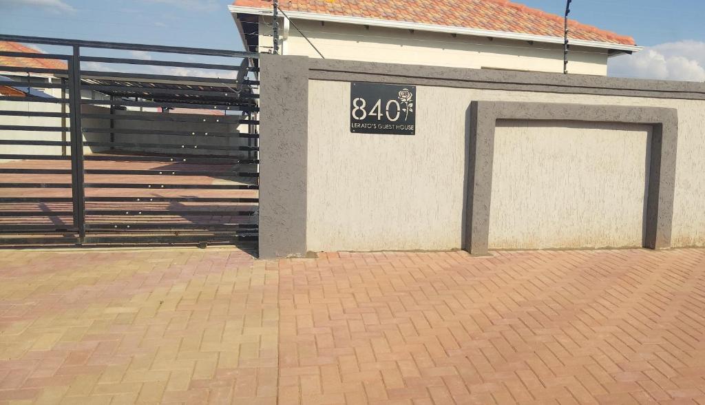 a building with a garage with a sign on it at Lerato's Guesthouse in Polokwane