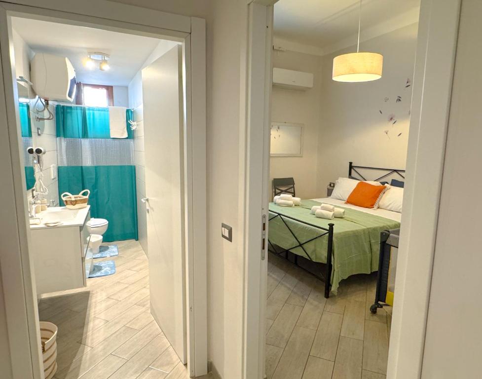 a small room with a bed and a bathroom at AGATHEA APARTMENT - Central Location, Just 50m from the Sea - Nettuno in Nettuno